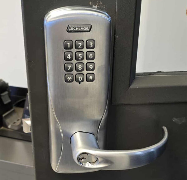 A Schlage keypad lock installed on a door.