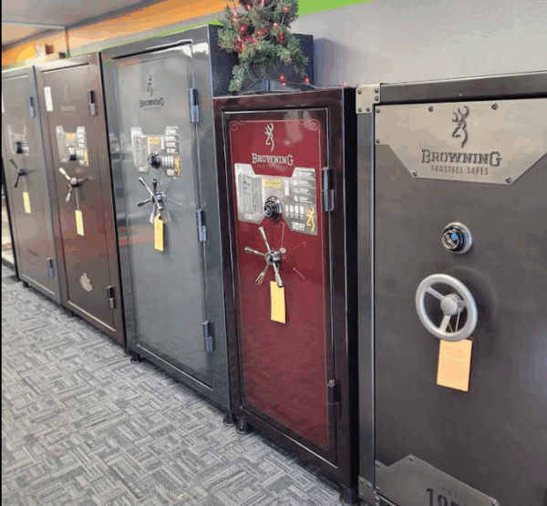 A variety of safes displayed in a locksmith showroom.