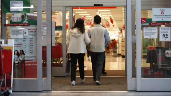 Two people enter the automatic doors of a Target store.